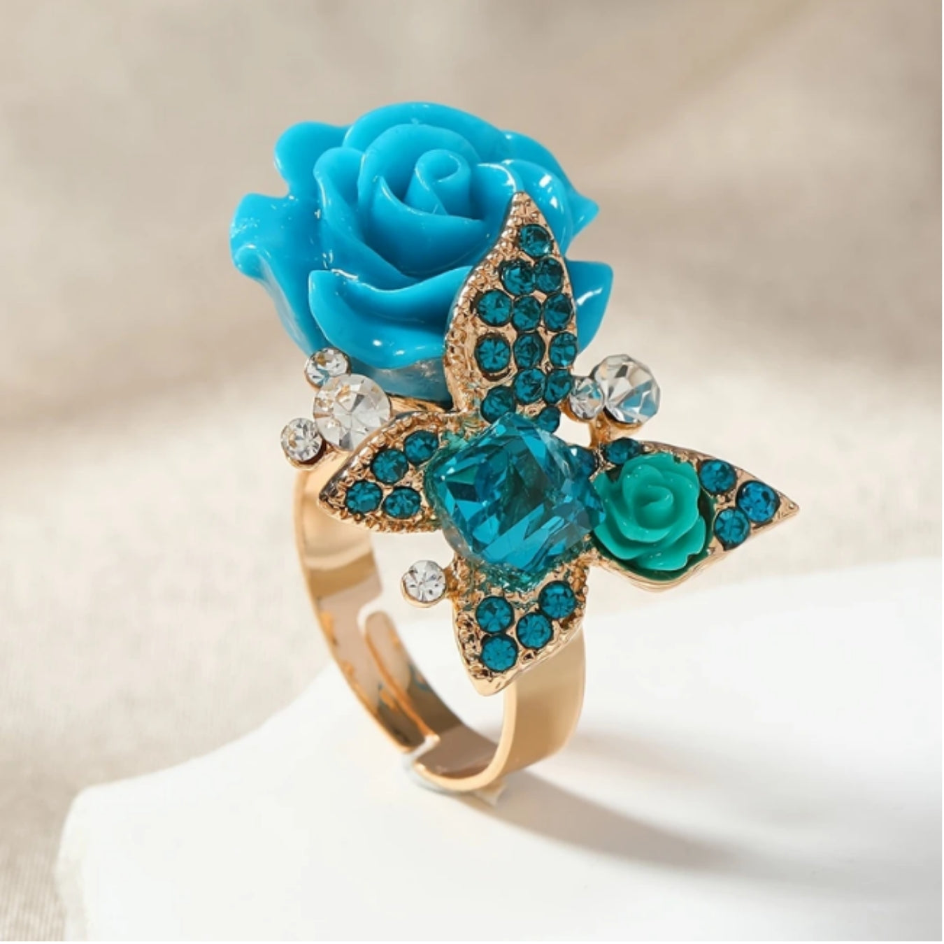 Goldring mit blauer Blume und Schmetterling